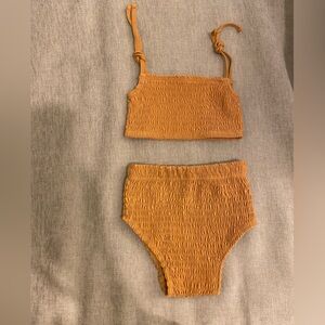 Kate Quinn burnt umber colored sun suit